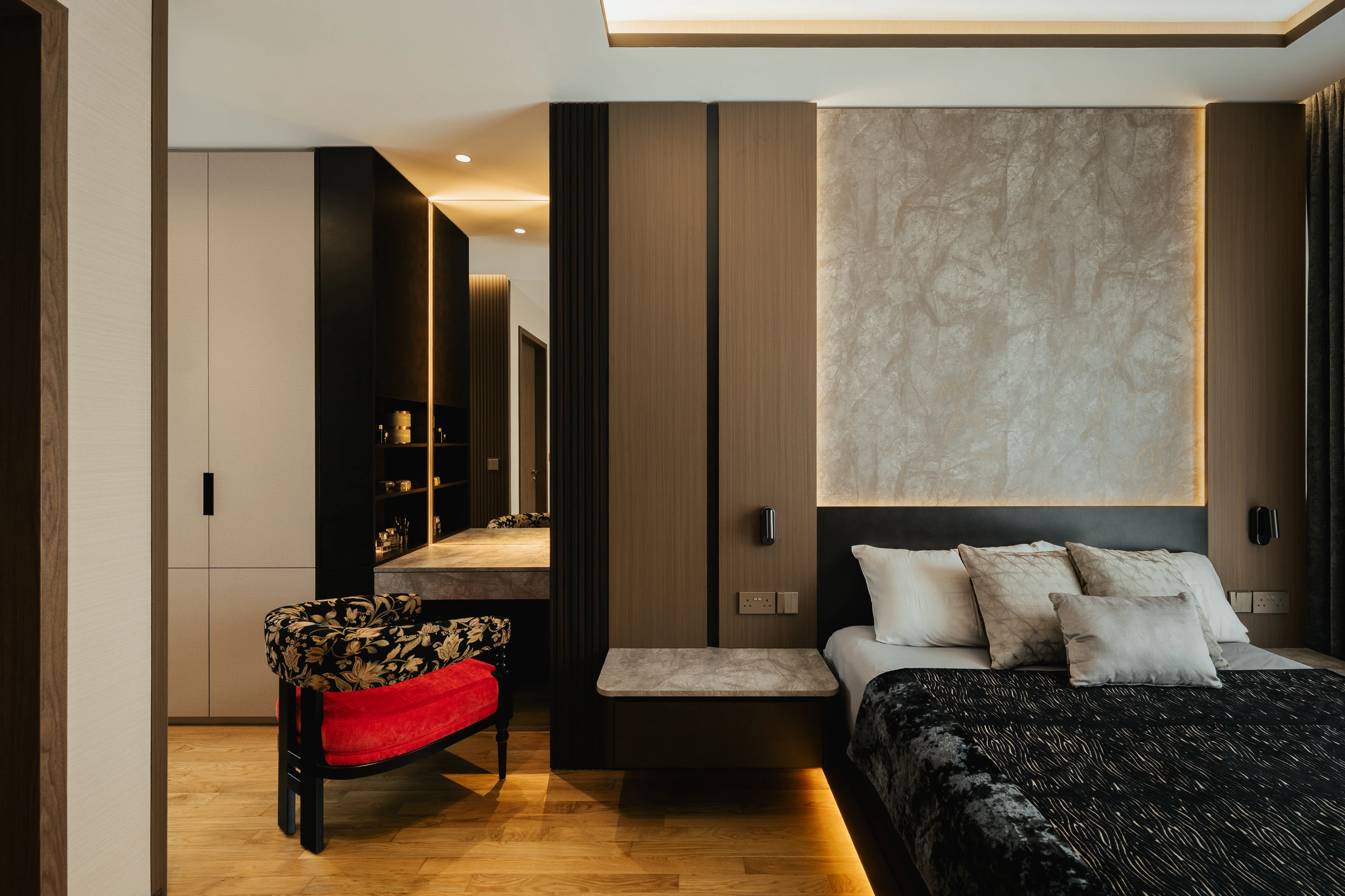 Master bedroom with dark timber and textured headboard wall by Edgeline Planners