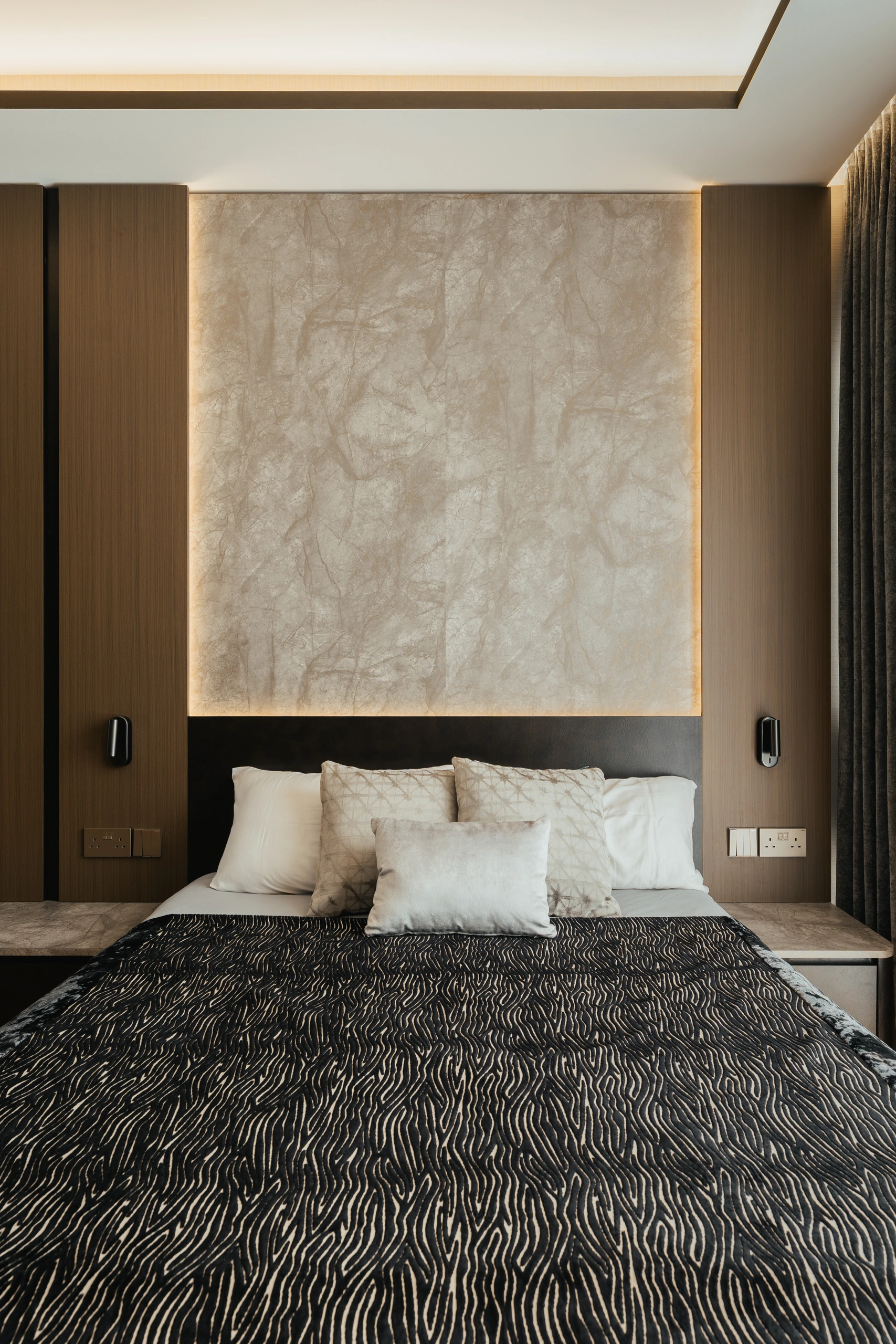 Master bedroom front view with timber headboard by Edgeline Planners