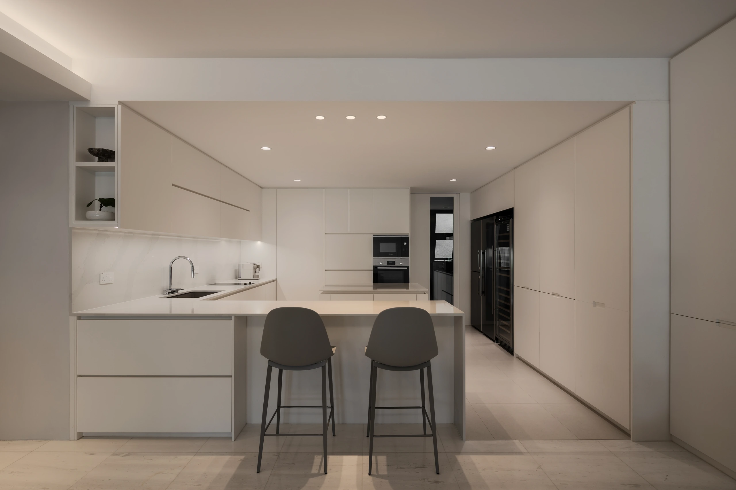 Kitchen island viewed from the dining connection by Edgeline Planners