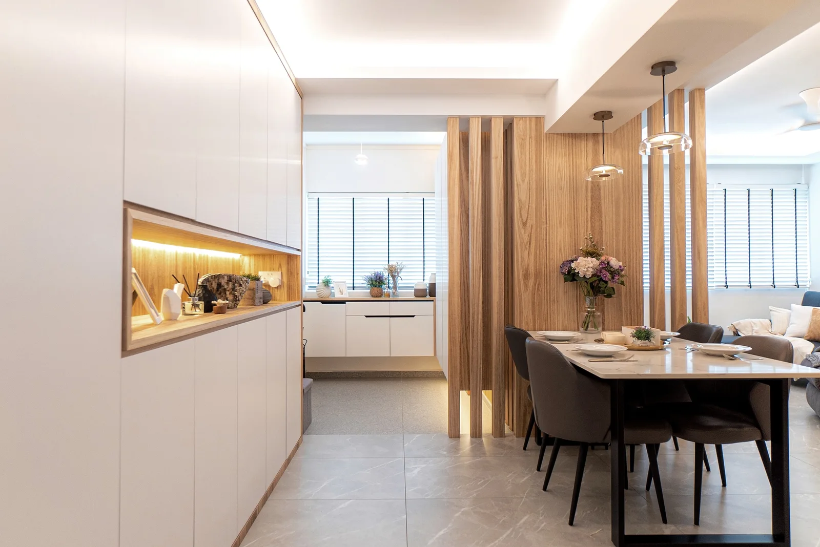 J Concept Designers &mdash; backlit display niche in white cabinetry with timber screen and dining
