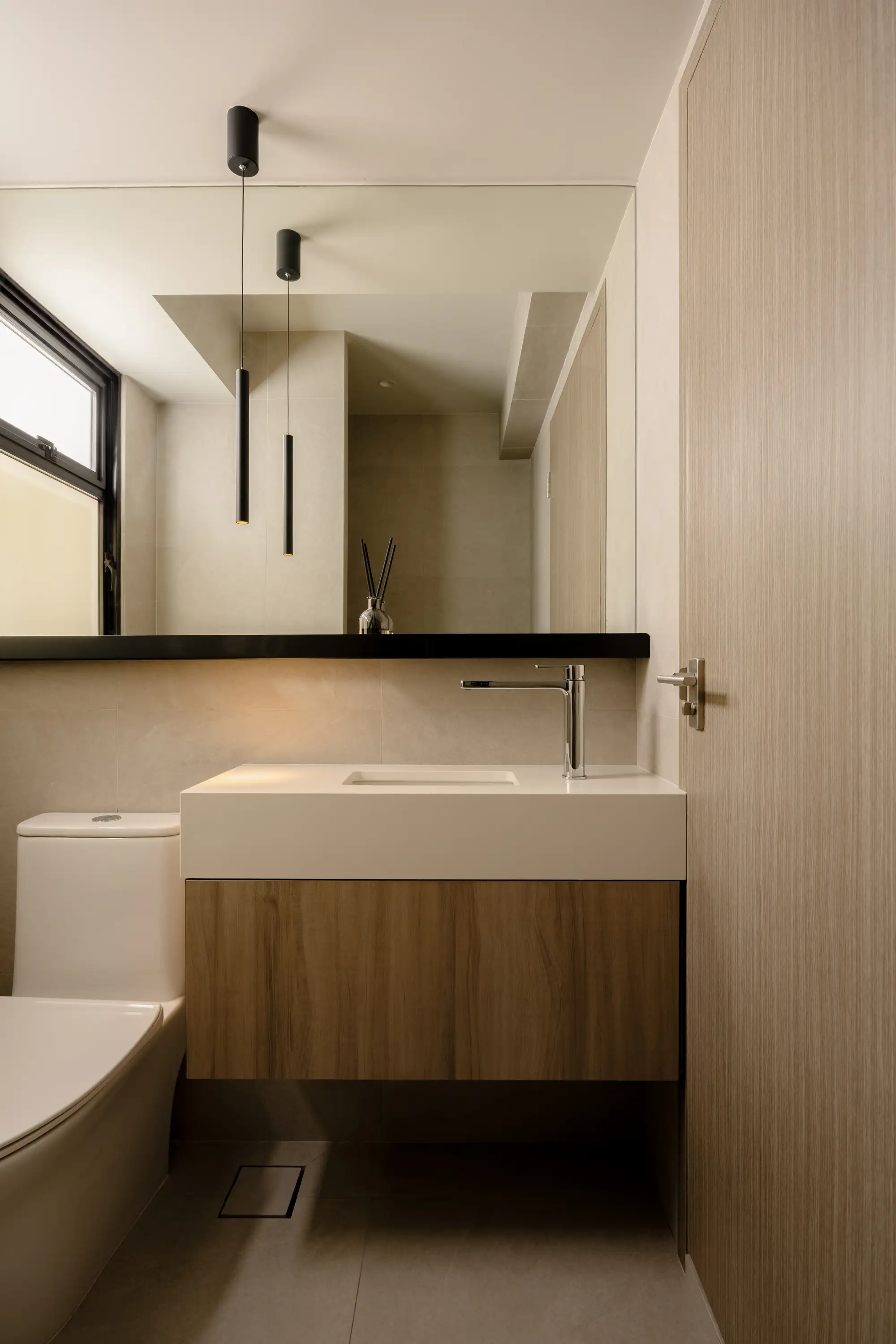 Warm grey bathroom with floating timber vanity and black shelf