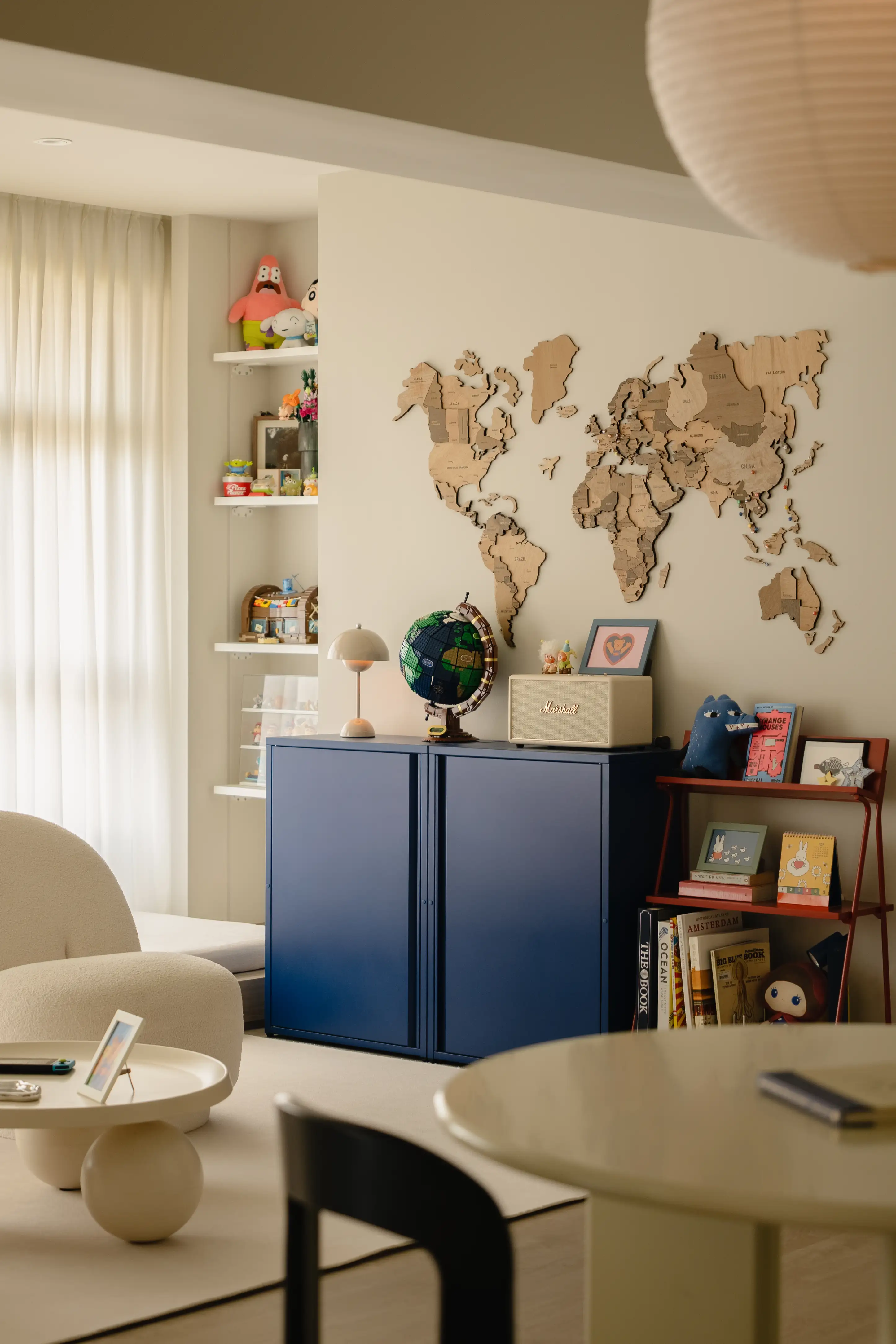 Blue cabinet, world map and personal memorabilia integrated into the living room