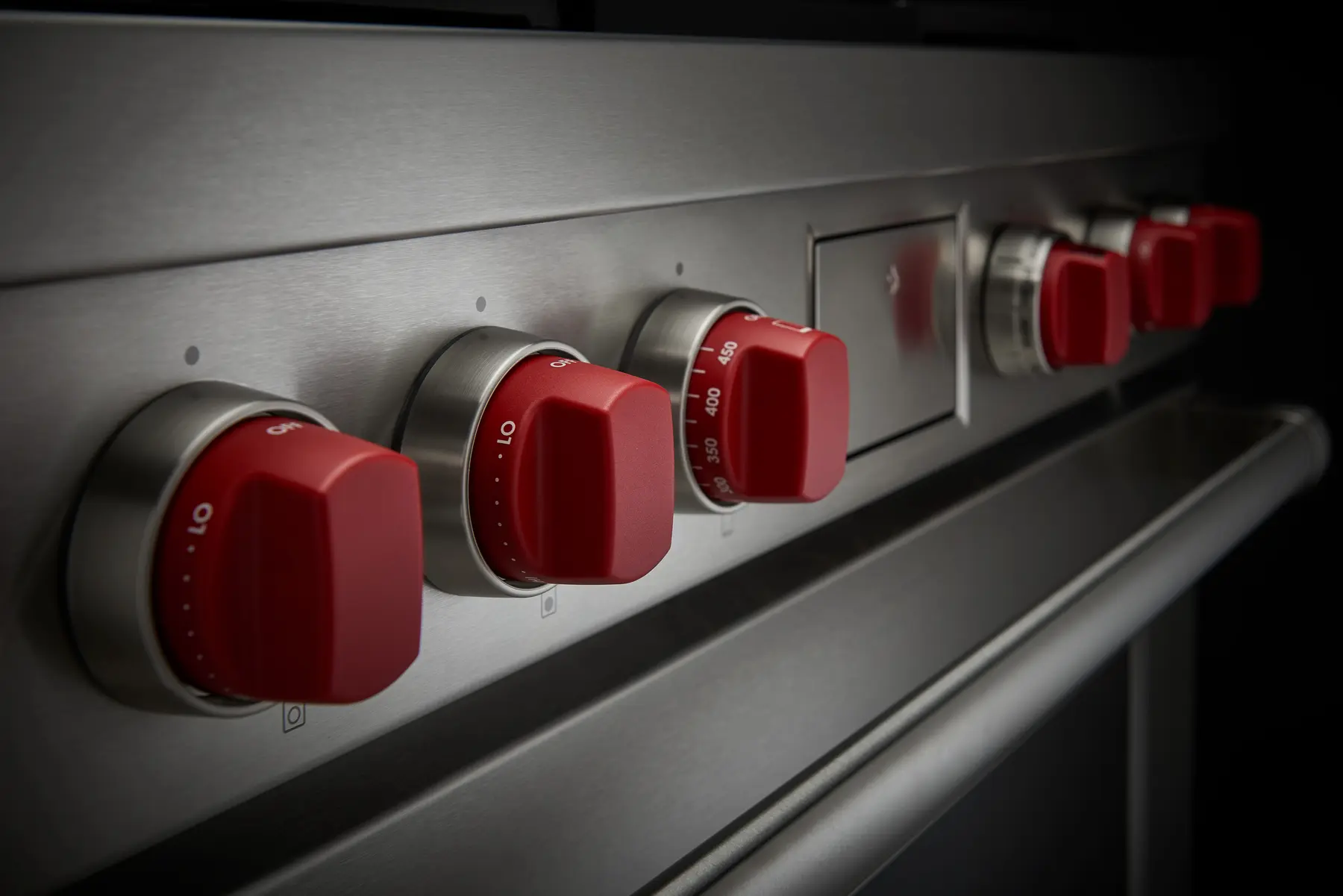 Close view of Wolf signature red control knobs