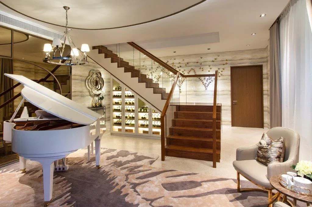 SuMisura &mdash; music lounge with grand piano and wine storage beneath staircase