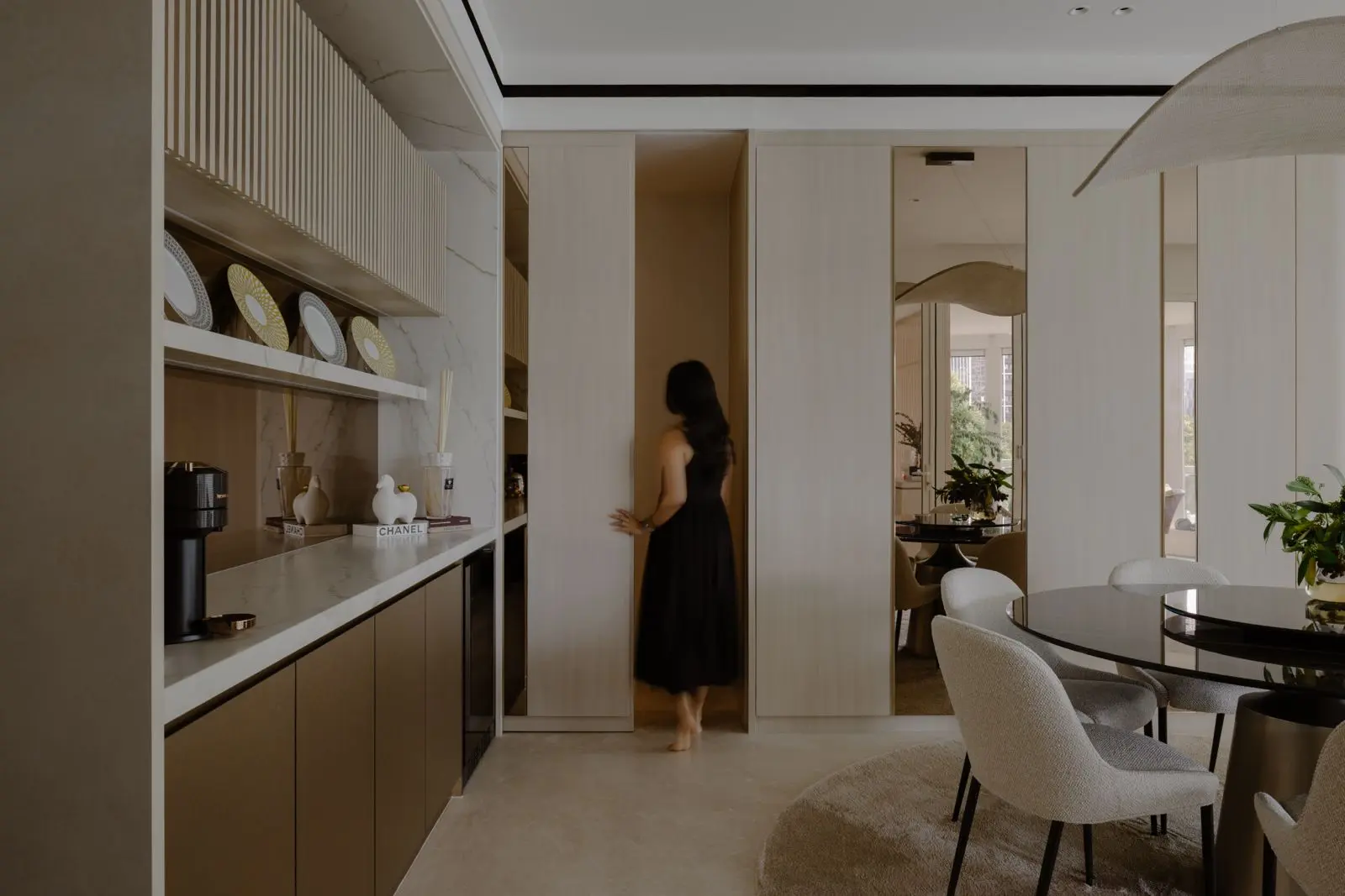 Dining room beside a bronze-toned pantry display cabinet